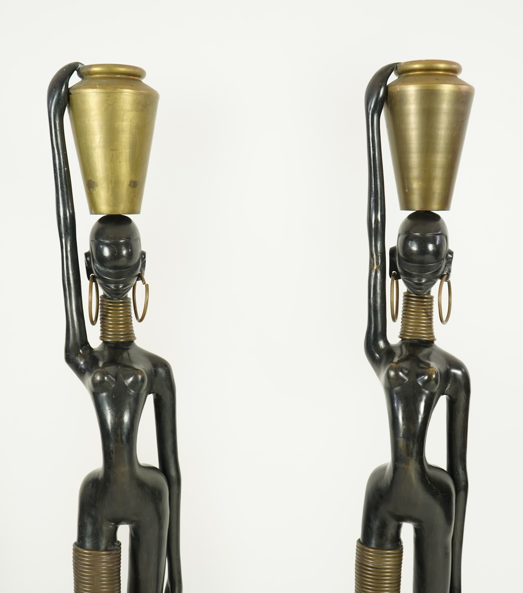 A large pair of Hagenauer style ebonised bronze 'Giraffe Woman' figures